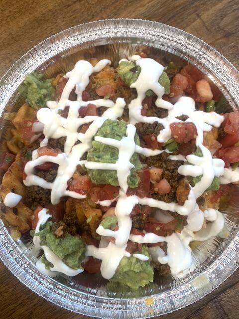 Colorful nachos with toppings and sauce