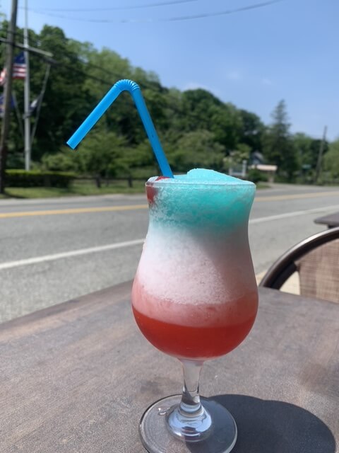 Colorful layered frozen drink outdoors