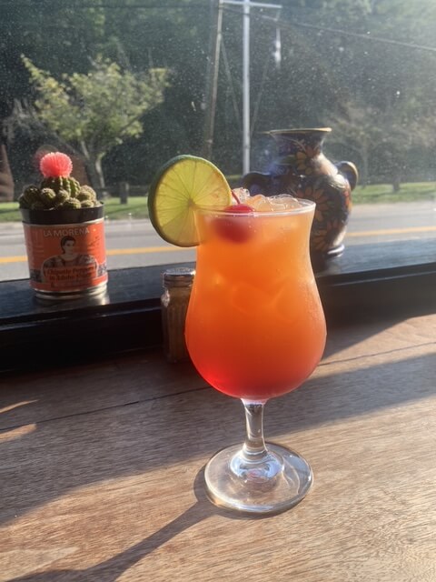 Colorful cocktail with lime garnish
