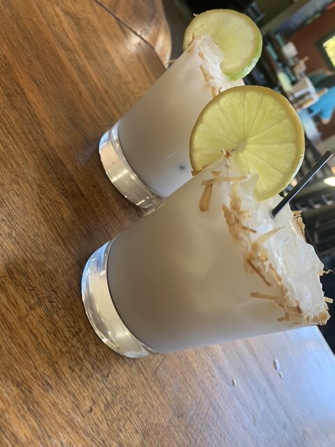 Two cocktails with lime garnish