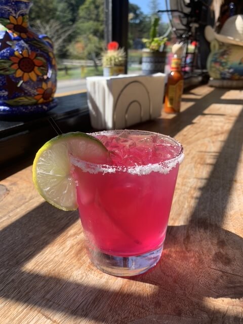Colorful cocktail with lime garnish